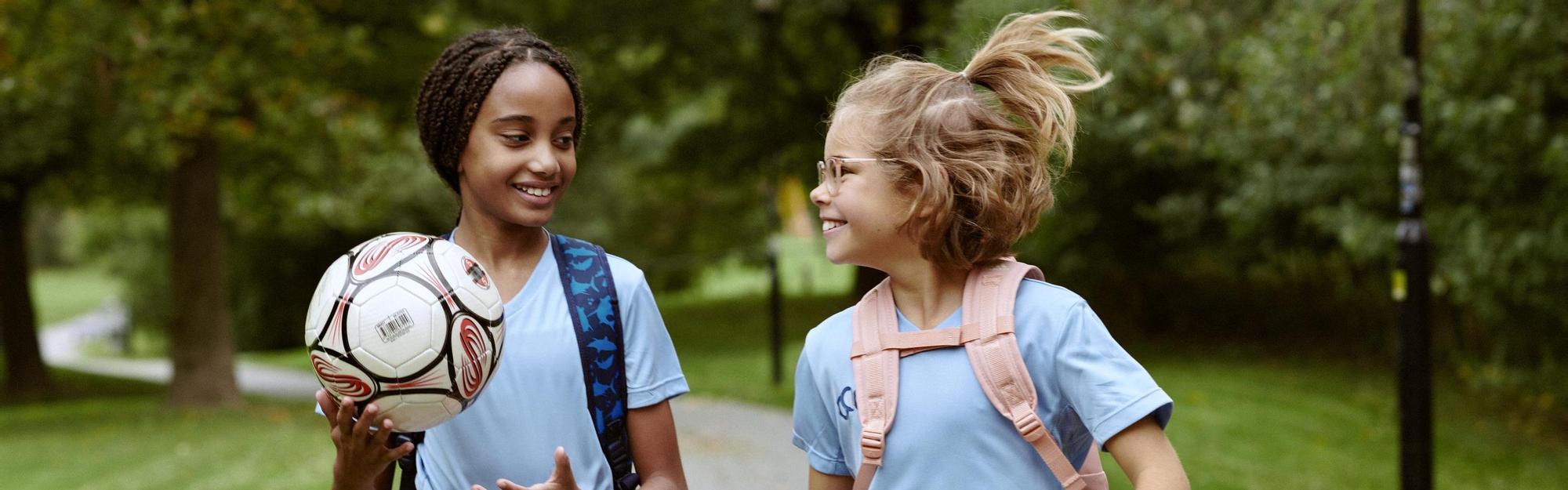 Two kids walking to soccer practice 