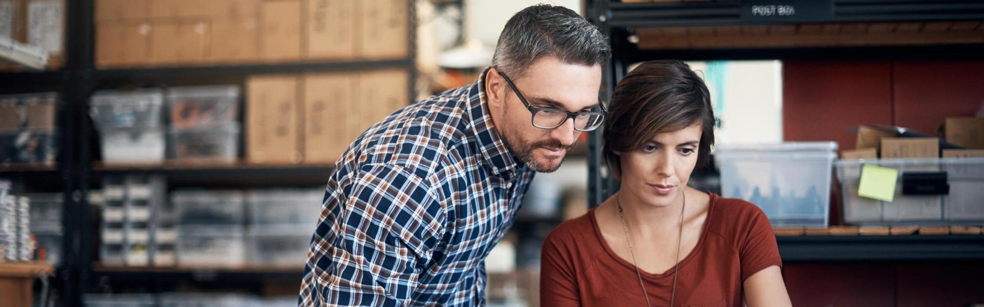 Man and woman in an industry using a laptop